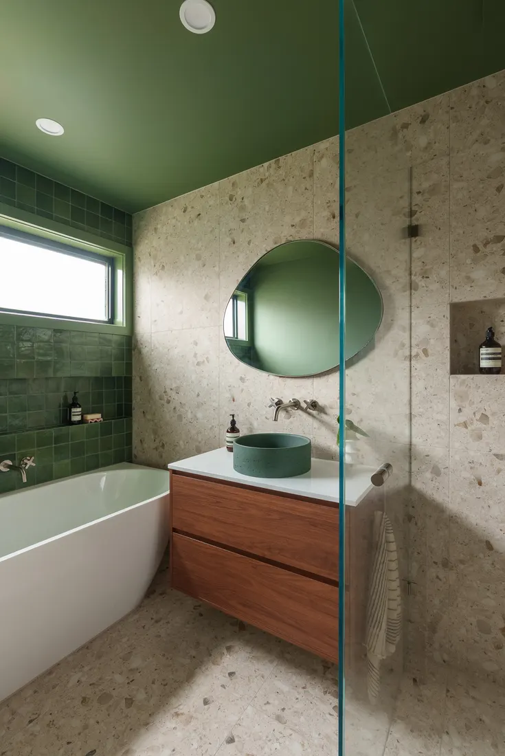 Green tiled bathroom with freestanding bath by MNA Builds